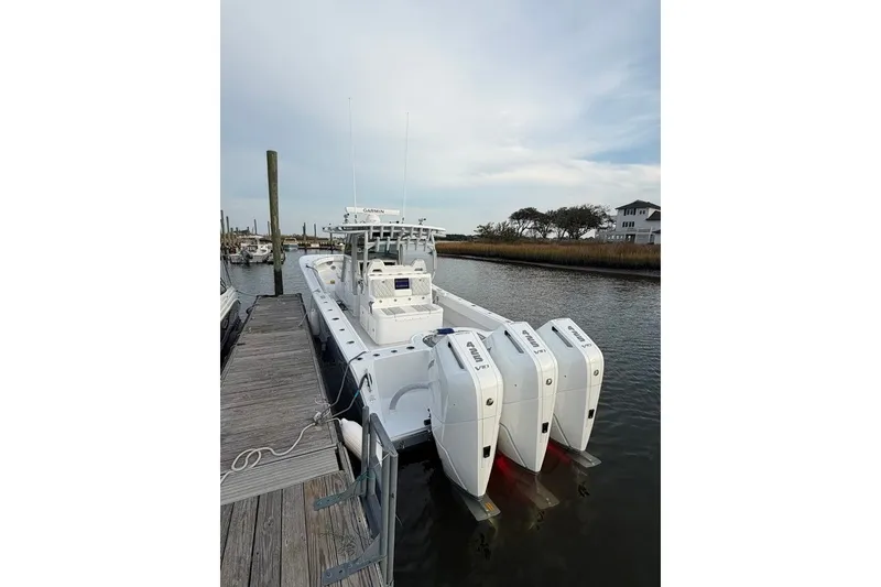 Slide: The Image of 2026 Onslow Bay 37 Tournament Edition boat docked with triple engines. - 113