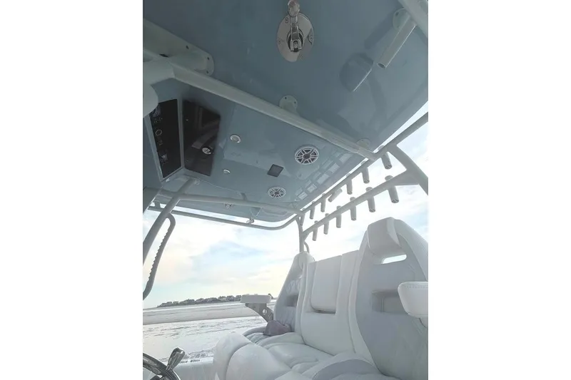 Slide: The Image of Interior view of 2026 Onslow Bay 37 Tournament Edition boat, featuring seating and overhead rod holders. - 57