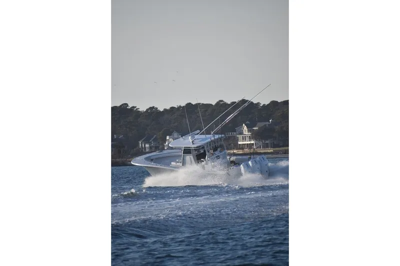 Slide: The Image of 2026 Onslow Bay 37 Tournament Edition boat navigating through waves near the shoreline. - 15