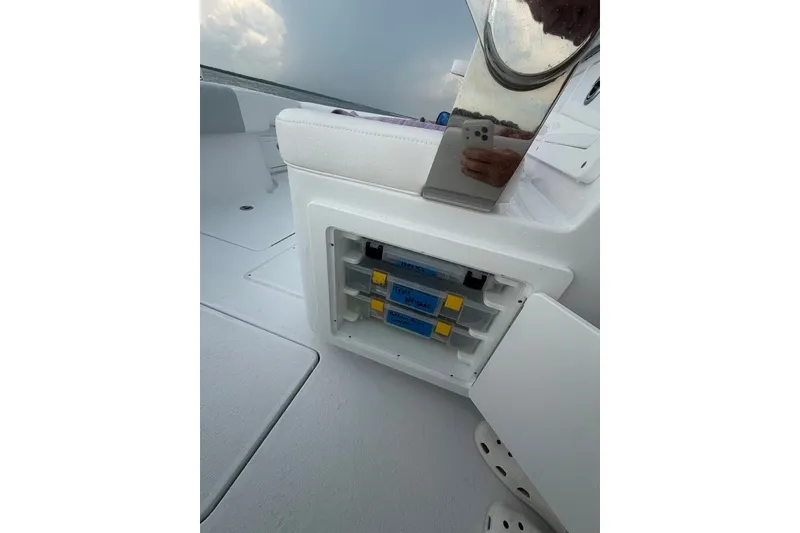 Slide: The Image of Onslow Bay 37 Tournament Edition 2026 boat storage compartment with tackle boxes. - 60