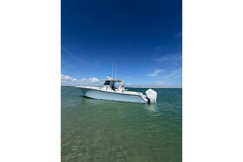 Slide: The Image of 2026 Onslow Bay 37 Tournament Edition boat anchored in clear waters under a blue sky. - 38