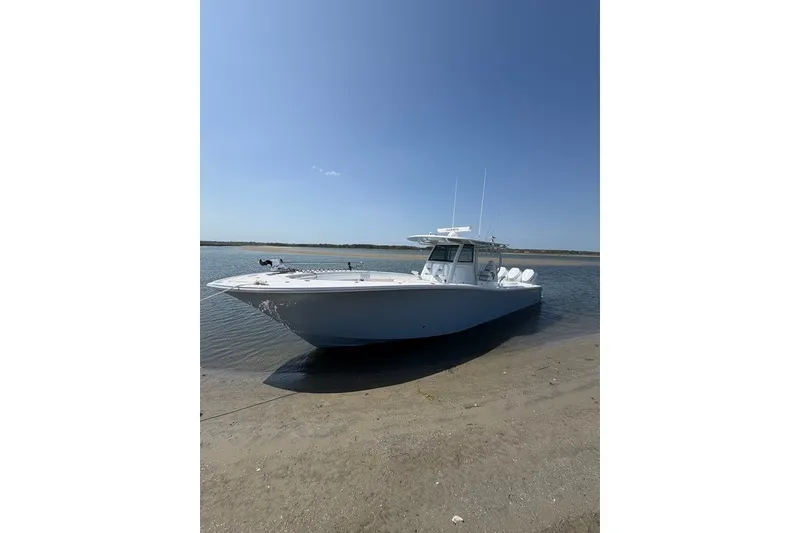 Slide: The Image of 2026 Onslow Bay 37 Tournament Edition boat on sandy shore under clear blue sky. - 29
