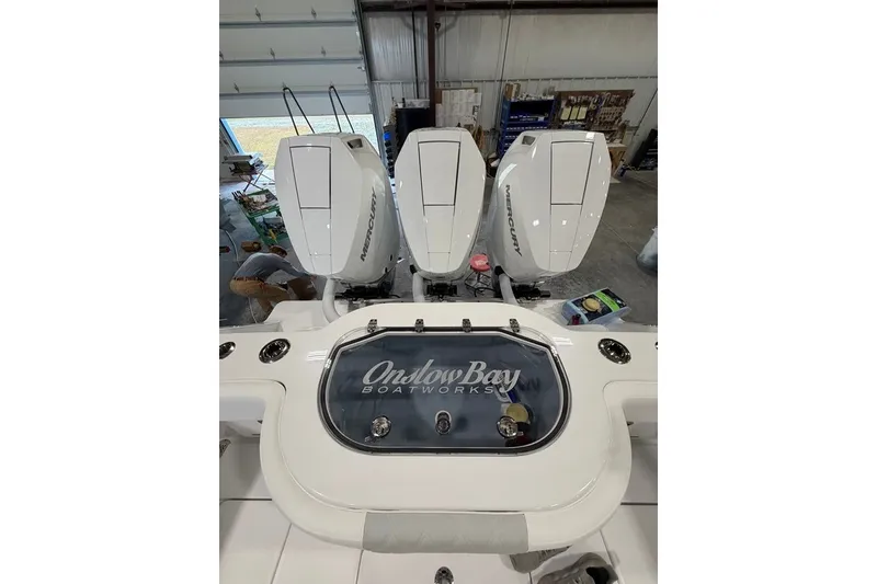 Slide: The Image of 2026 Onslow Bay 37 Tournament Edition boat with triple Mercury engines in a garage. - 81