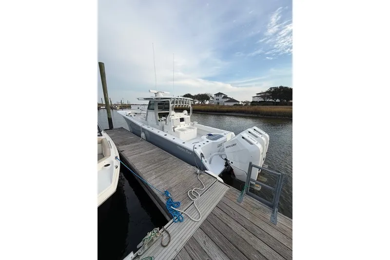 Slide: The Image of 2026 Onslow Bay 37 Tournament Edition boat docked with triple Mercury engines. - 114