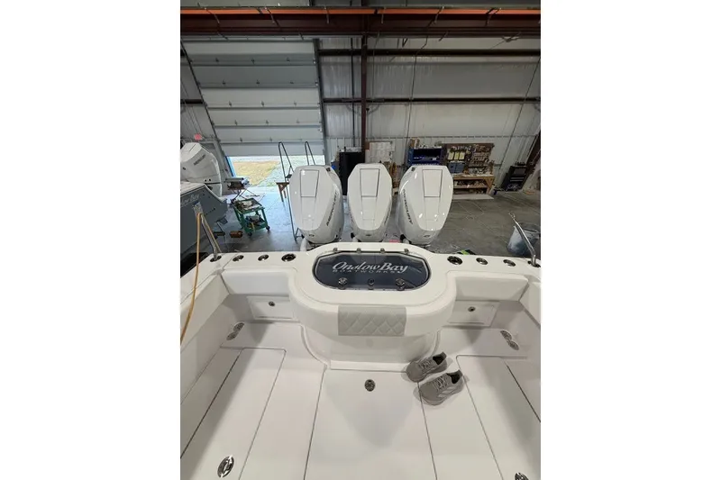 Slide: The Image of 2026 Onslow Bay 37 Tournament Edition boat in a warehouse with triple engines. - 80