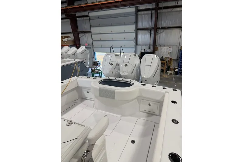 Slide: The Image of 2026 Onslow Bay 37 Tournament Edition boat interior with multiple outboard motors in a warehouse. - 78