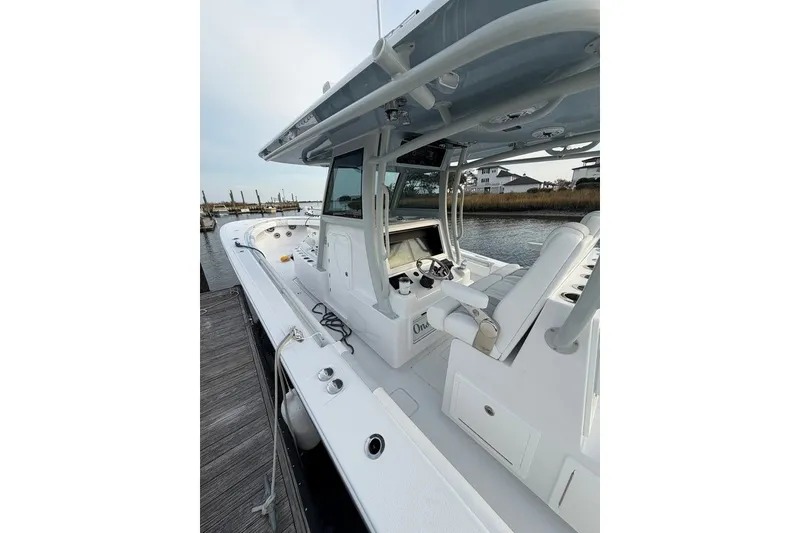 Slide: The Image of 2026 Onslow Bay 37 Tournament Edition boat docked, showcasing sleek design and advanced controls. - 116