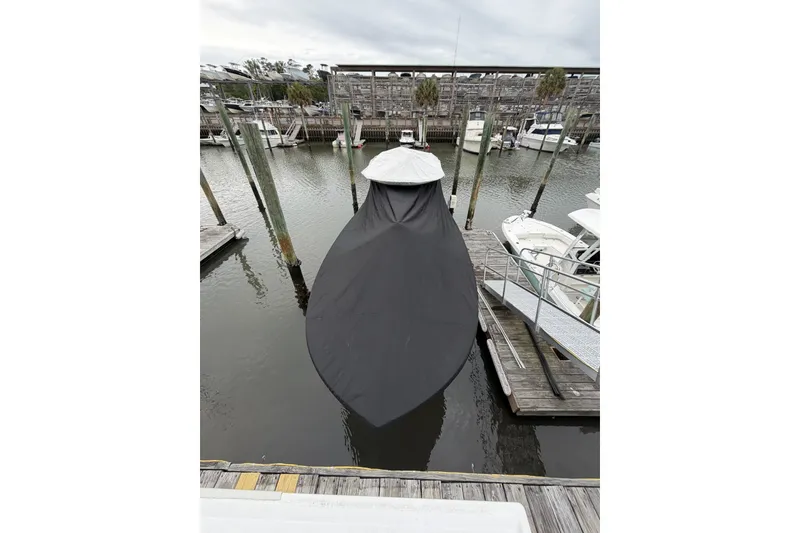 Slide: The Image of 2026 Onslow Bay 37 Tournament Edition boat covered at marina dock. - 129