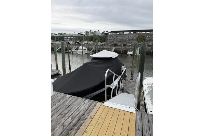 Slide: The Image of Covered 2026 Onslow Bay 37 Tournament Edition boat docked at marina. - 128