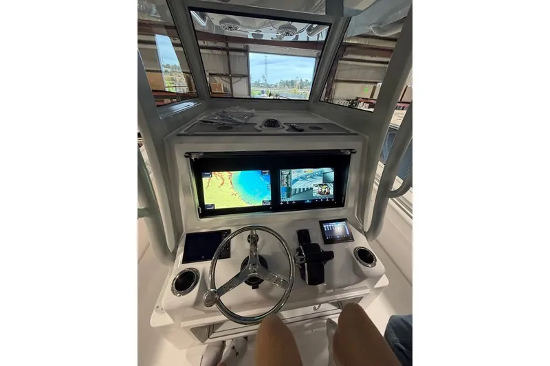 Slide: The Image of 2026 Onslow Bay 37 Tournament Edition boat dashboard with navigation screens and controls. - 84