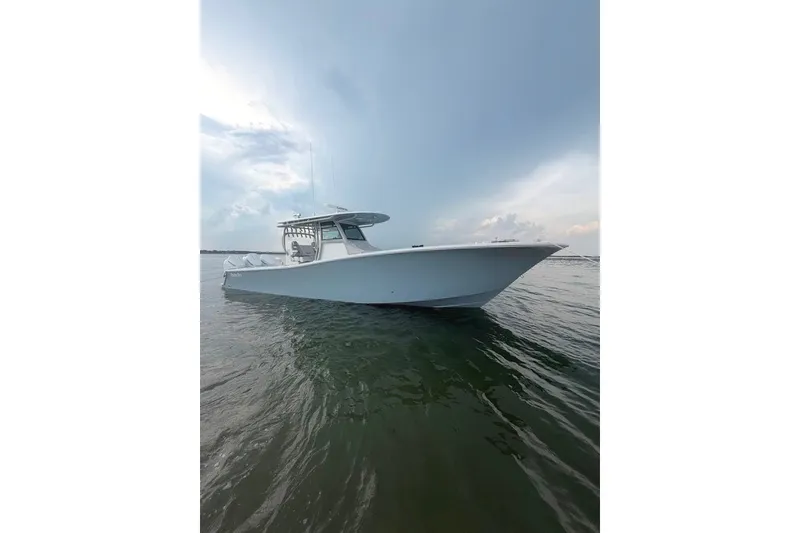 Slide: The Image of 2026 Onslow Bay 37 Tournament Edition boat on calm water under a cloudy sky. - 52