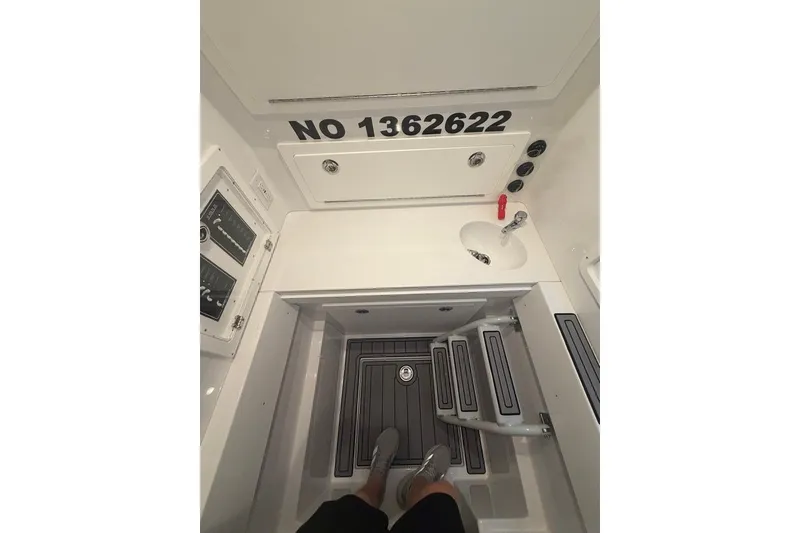 Slide: The Image of Interior view of 2026 Onslow Bay 37 Tournament Edition boat, featuring storage and control panels. - 25