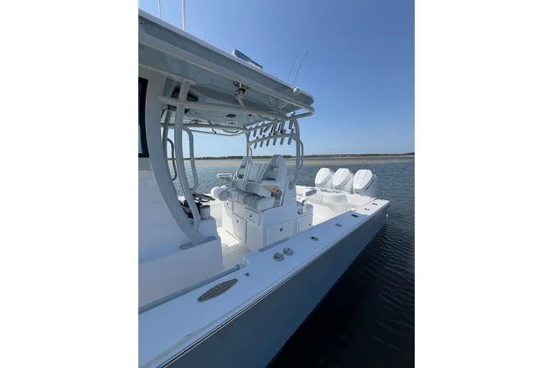 Slide: The Image of 2026 Onslow Bay 37 Tournament Edition boat on calm water, showcasing sleek design and seating. - 32