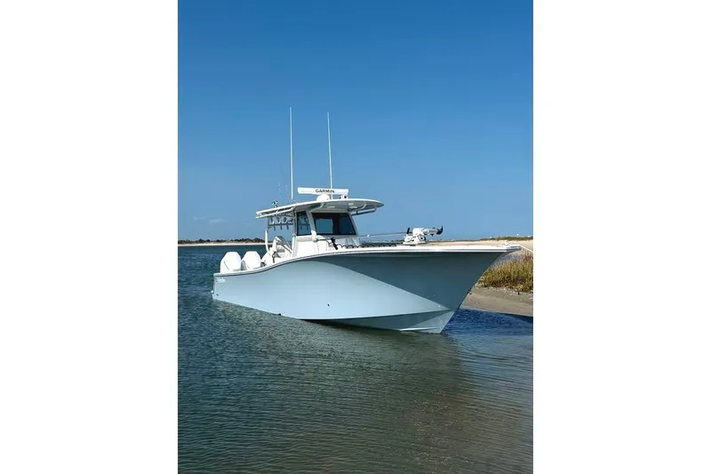 Slide: The Image of 2026 Onslow Bay 37 Tournament Edition boat on calm water under clear blue sky. - 35
