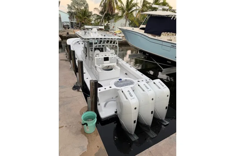 Slide: The Image of 2026 Onslow Bay 37 Tournament Edition boat docked with triple engines. - 122