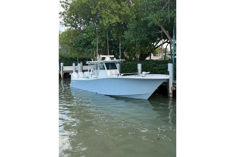 Slide: The Image of 2026 Onslow Bay 37 Tournament Edition boat docked by lush greenery. - 121