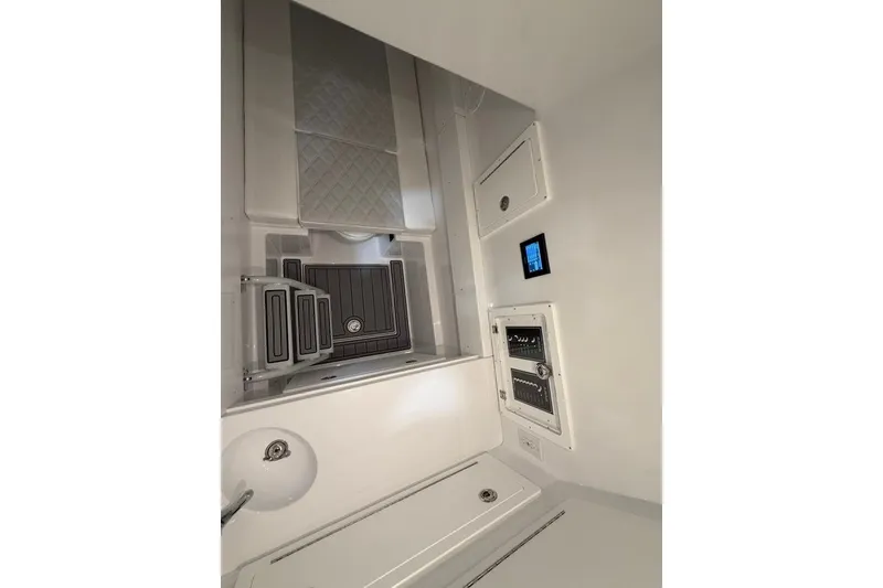 Slide: The Image of Interior of 2026 Onslow Bay 37 Tournament Edition boat, featuring modern control panels and sink. - 89
