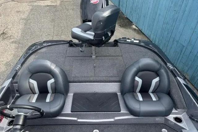 Slide: The Image of 2026 Nitro Z17 boat interior with three black and gray seats, steering wheel, and carpeted deck. - 12