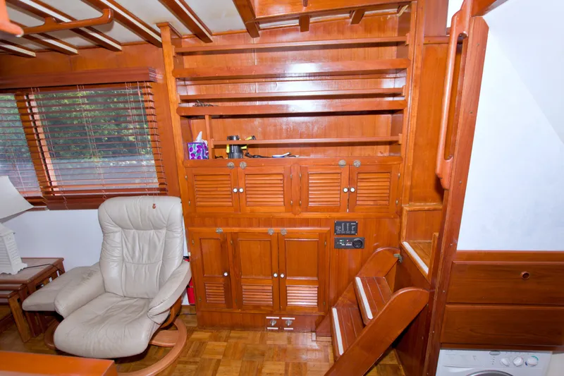 Slide: The Image of Interior of 1980 Kadey-Krogen 42 yacht with wooden cabinetry and beige recliner chair. - 47