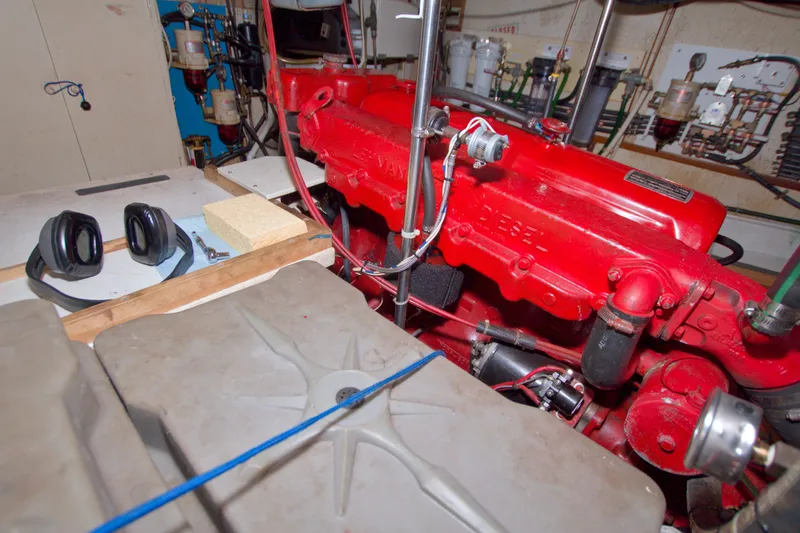 Slide: The Image of Engine room of a 1980 Kadey-Krogen 42 with a red diesel engine. - 86