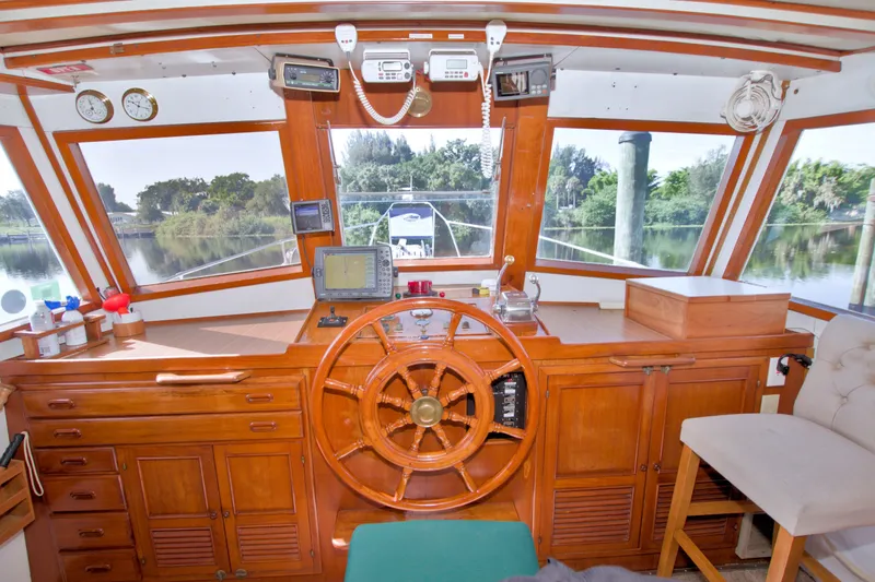 Slide: The Image of Helm of 1980 Kadey-Krogen 42 boat with wooden steering wheel and navigation equipment. - 51