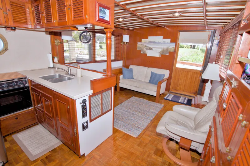 Slide: The Image of Interior of 1980 Kadey-Krogen 42 yacht with cozy seating and wooden cabinetry. - 77