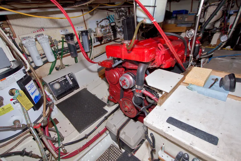 Slide: The Image of Engine room of a 1980 Kadey-Krogen 42 boat, featuring a red engine and various equipment. - 80