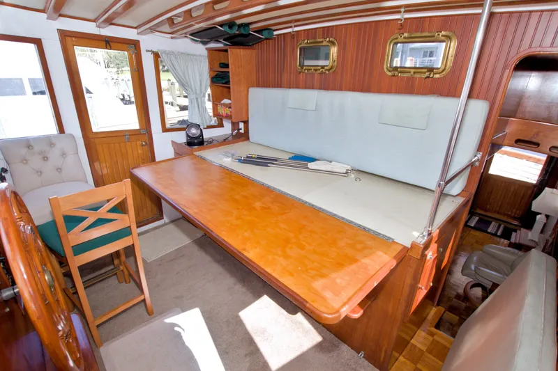 Slide: The Image of Interior of a 1980 Kadey-Krogen 42 boat with wooden table and seating area. - 57