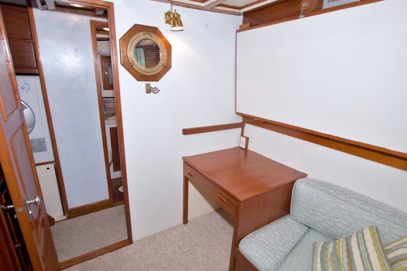 Slide: The Image of Cozy interior of 1980 Kadey-Krogen 42 yacht with desk, sofa, and porthole. - 64