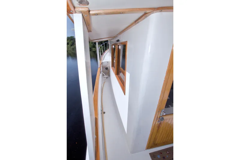 Slide: The Image of Side deck view of a 1980 Kadey-Krogen 42 boat with wooden accents. - 23