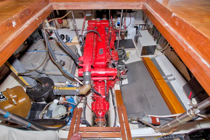 Slide: The Image of Engine room of a 1980 Kadey-Krogen 42 boat, featuring a red engine and various components. - 87