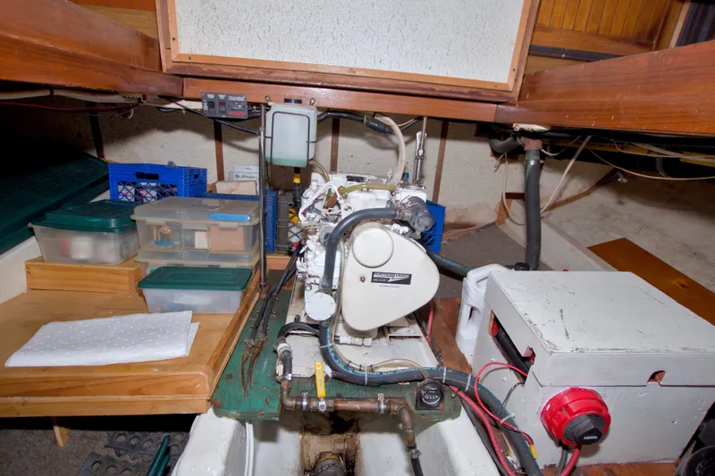 Slide: The Image of Engine room of a 1980 Kadey-Krogen 42 boat with organized storage containers. - 96