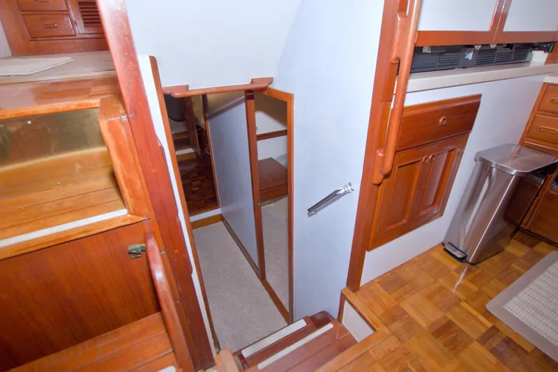 Slide: The Image of Interior of 1980 Kadey-Krogen 42 yacht, featuring wooden cabinetry and stairs. - 59