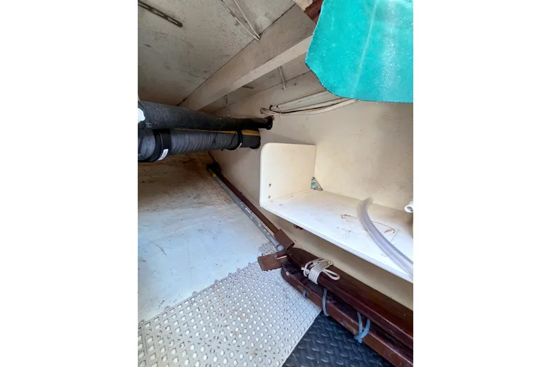 Slide: The Image of Interior view of a 1980 Kadey-Krogen 42 boat, showcasing storage and piping. - 101