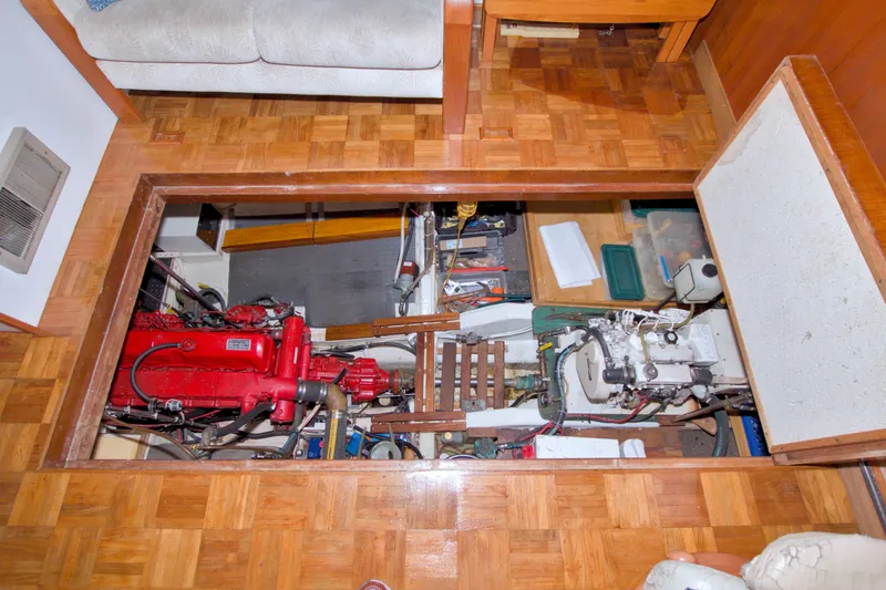 Slide: The Image of Engine room of a 1980 Kadey-Krogen 42 yacht with visible machinery and tools. - 84