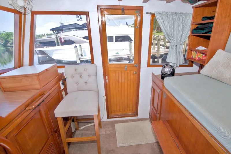 Slide: The Image of Cozy interior of 1980 Kadey-Krogen 42 yacht with wooden furnishings and waterfront view. - 55