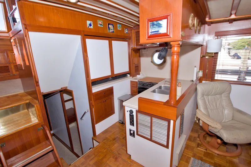 Slide: The Image of Interior of 1980 Kadey-Krogen 42 yacht with wooden cabinetry and cozy seating area. - 42