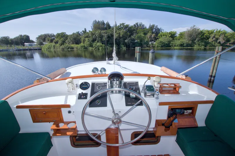Slide: The Image of Helm of 1980 Kadey-Krogen 42 yacht with scenic river view. - 15