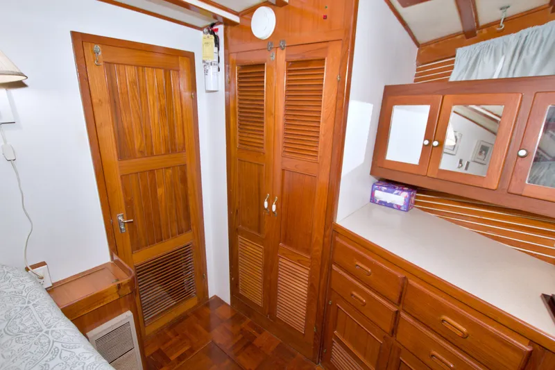 Slide: The Image of Wooden interior of 1980 Kadey-Krogen 42 yacht with cabinets and mirror. - 70