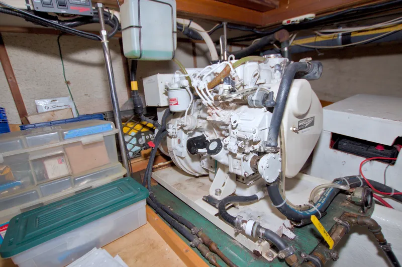 Slide: The Image of Engine room of a 1980 Kadey-Krogen 42 boat, featuring mechanical components and storage. - 97