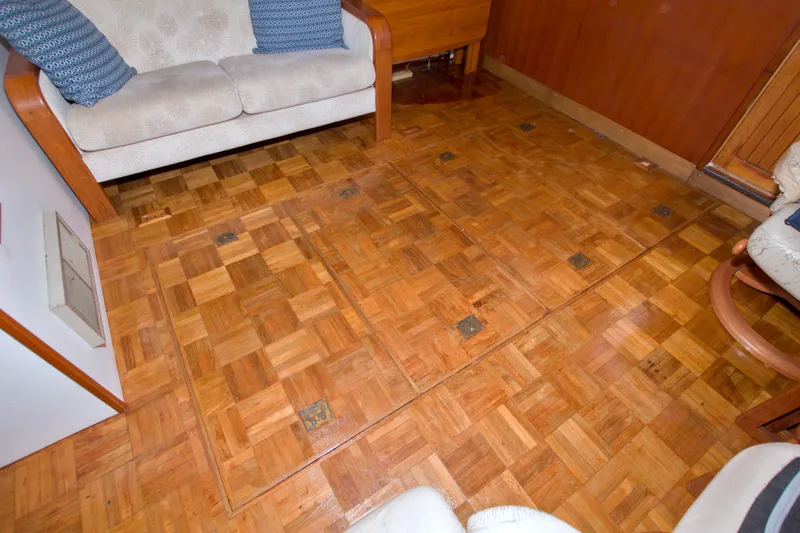 Slide: The Image of Interior of 1980 Kadey-Krogen 42 with parquet flooring and cushioned seating. - 82