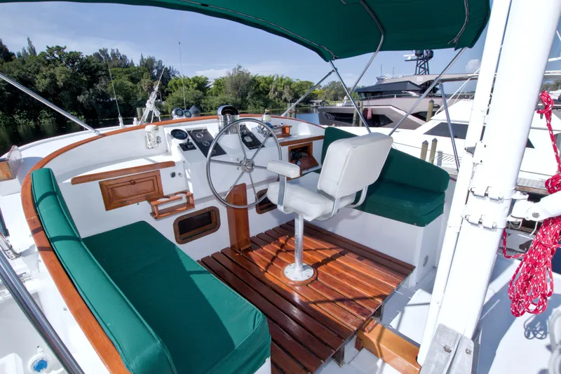 Slide: The Image of Cockpit of 1980 Kadey-Krogen 42 yacht with green seating and wooden flooring. - 18