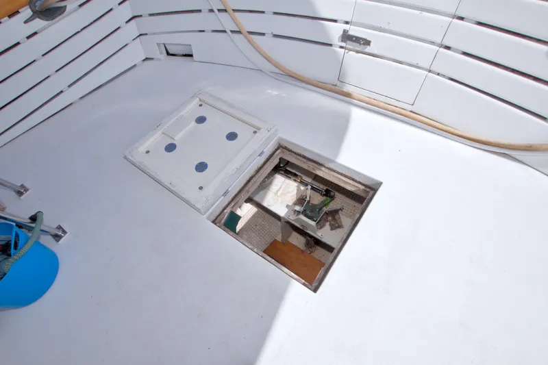 Slide: The Image of Open hatch on 1980 Kadey-Krogen 42 boat deck, revealing storage compartment. - 100