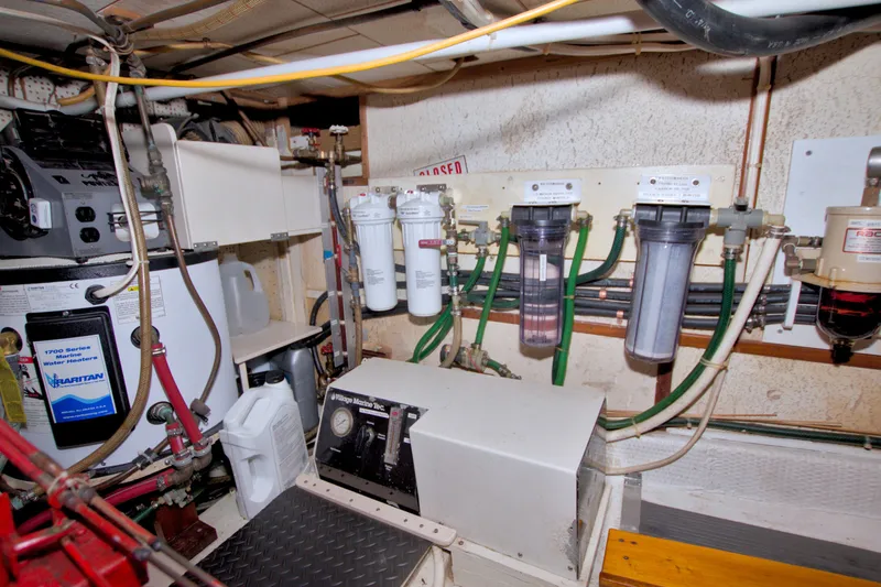 Slide: The Image of Engine room of a 1980 Kadey-Krogen 42 with water filtration system and equipment. - 89