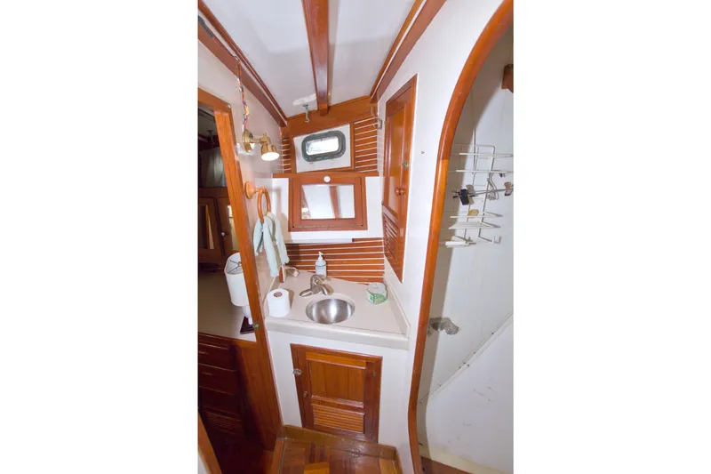 Slide: The Image of 1980 Kadey-Krogen 42 yacht bathroom with wooden accents, sink, and mirror. - 73