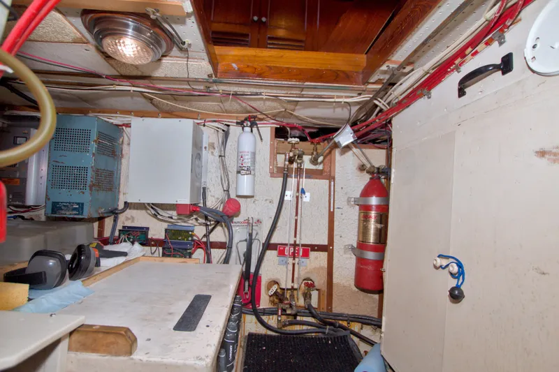 Slide: The Image of Engine room of a 1980 Kadey-Krogen 42 boat, featuring equipment and wiring. - 91