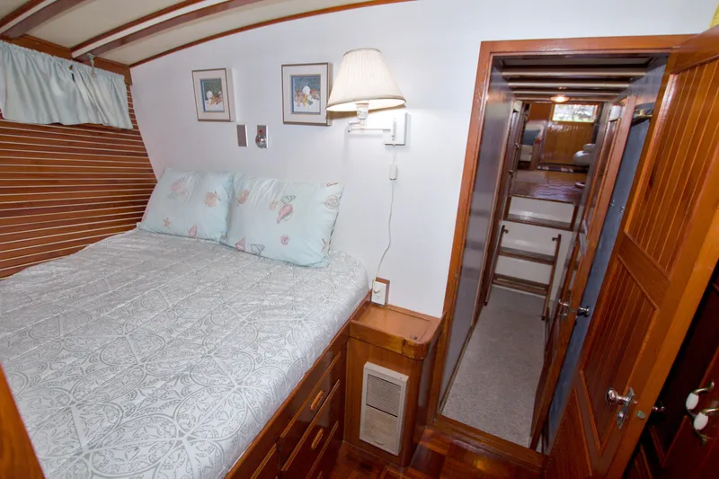Slide: The Image of Cozy bedroom interior of 1980 Kadey-Krogen 42 yacht with wooden accents and nautical decor. - 76