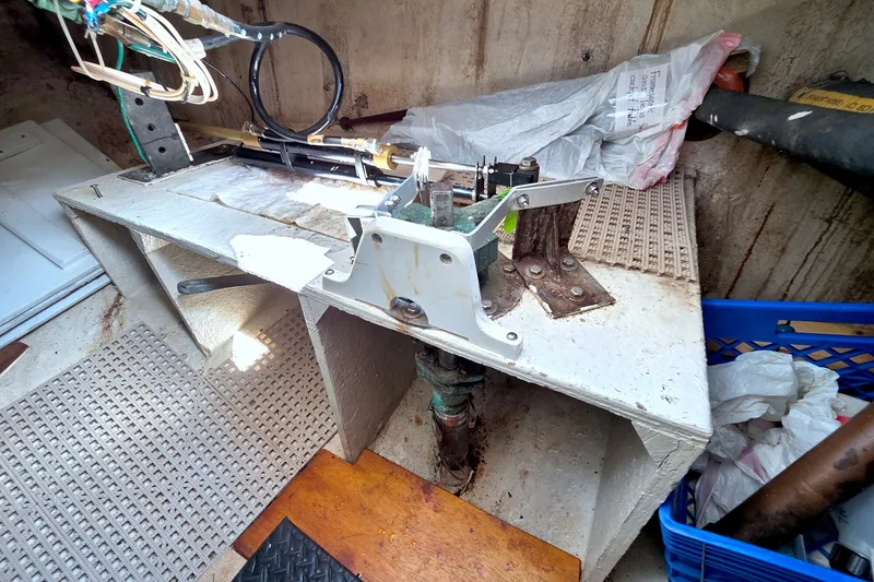 Slide: The Image of Interior of a 1980 Kadey-Krogen 42 boat showing mechanical components and storage area. - 103