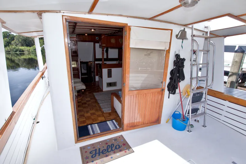 Slide: The Image of Kadey-Krogen 42 yacht interior, 1980 model, featuring wooden door, ladder, and nautical decor. - 38
