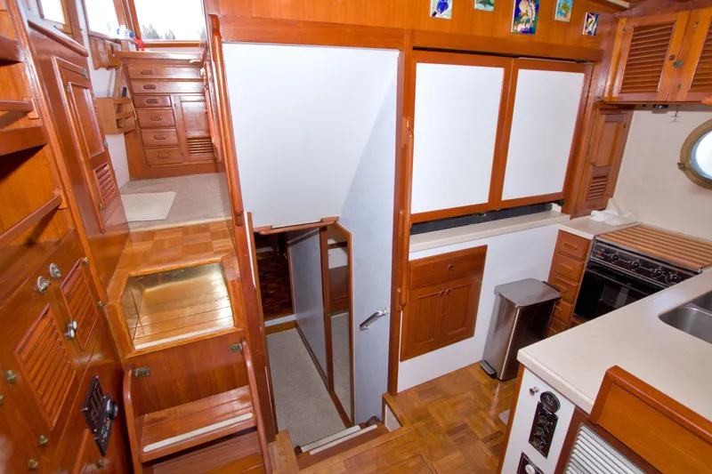 Slide: The Image of Interior of a 1980 Kadey-Krogen 42 yacht featuring wooden cabinetry and modern kitchen amenities. - 46